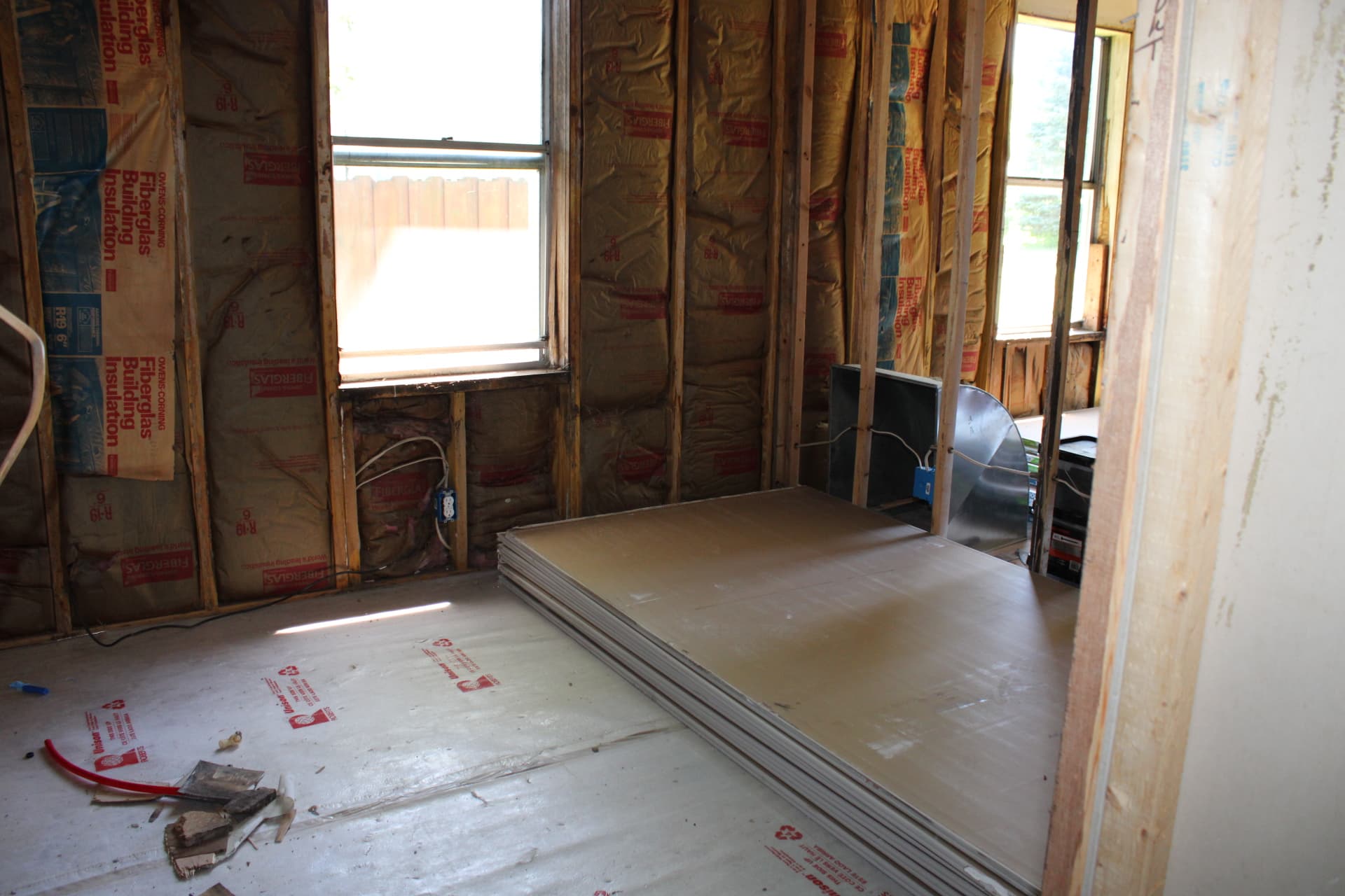 Room framing, insulation, and drywall materials during construction